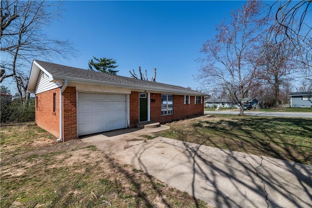 single story home featuring brick siding, an attached garage, driveway, and a front yard