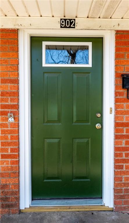 property entrance featuring brick siding