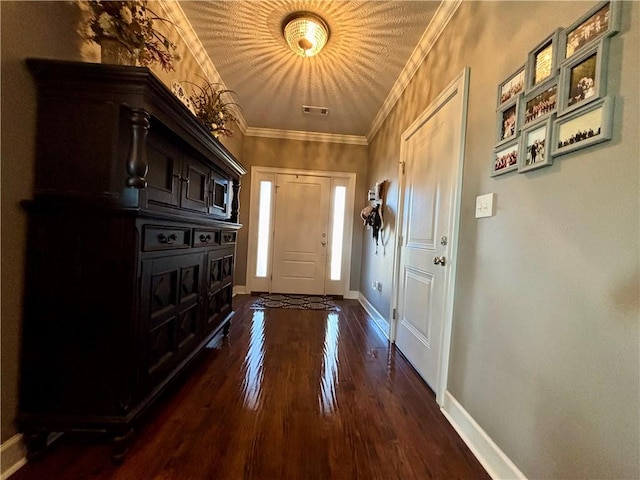 interior space featuring visible vents, baseboards, ornamental molding, and dark wood-style flooring