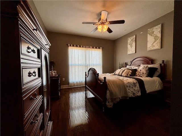 bedroom featuring baseboards, a ceiling fan, and dark wood-style flooring