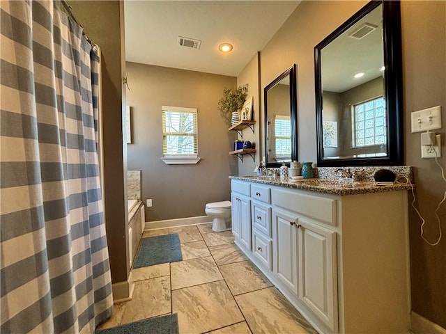 bathroom with visible vents, curtained shower, toilet, and double vanity