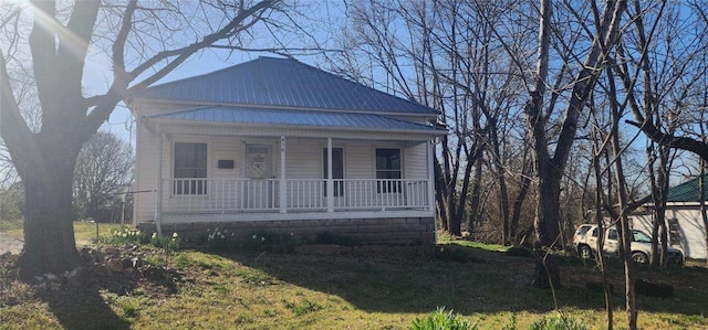 bungalow with metal roof and a porch