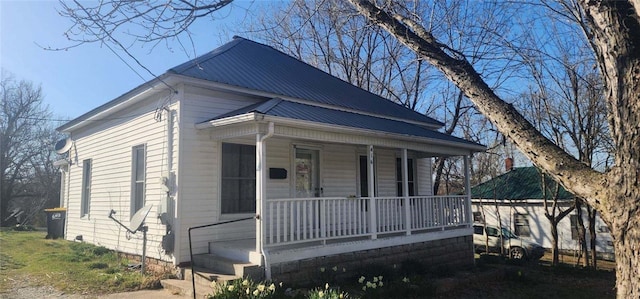 view of front of property featuring covered porch and metal roof