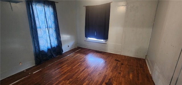 unfurnished room with wood-type flooring