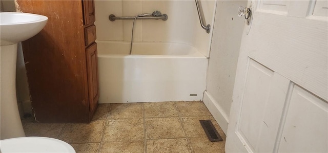 bathroom featuring visible vents and a tub to relax in