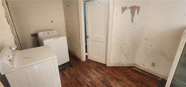 clothes washing area featuring washing machine and clothes dryer, laundry area, and dark wood-style flooring