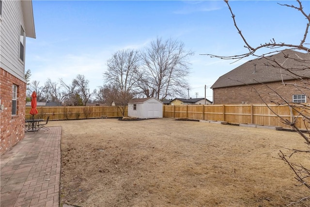 view of yard featuring a fenced backyard, a patio, a storage shed, and an outdoor structure