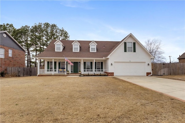 cape cod-style house featuring a shingled roof, fence, concrete driveway, covered porch, and an attached garage