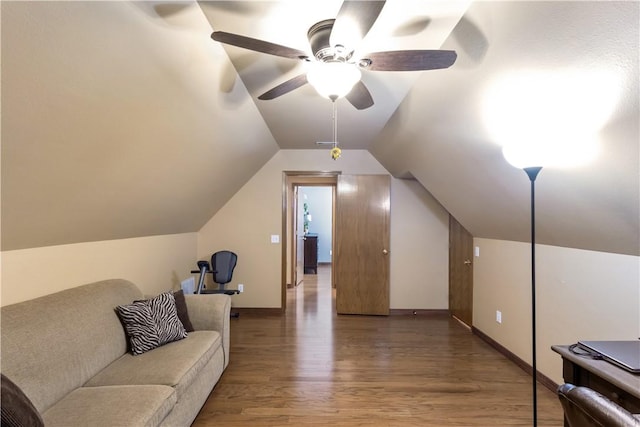 interior space featuring ceiling fan, baseboards, lofted ceiling, and wood finished floors