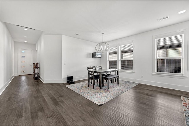 dining room with dark wood-type flooring, plenty of natural light, and visible vents