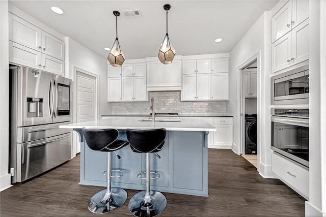 kitchen with visible vents, appliances with stainless steel finishes, white cabinets, and dark wood-style flooring