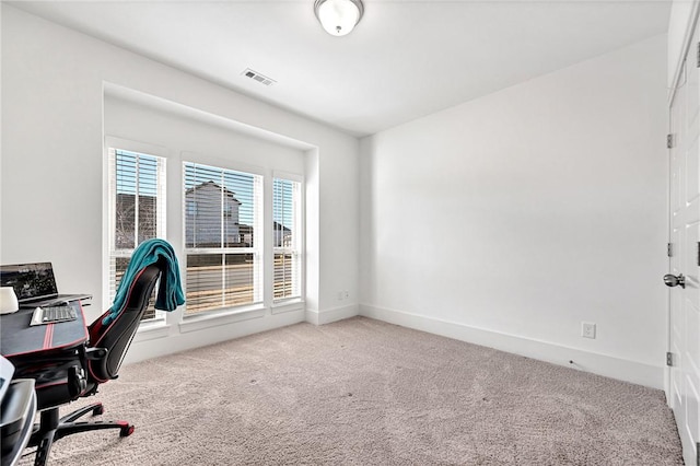 office space featuring visible vents, baseboards, and light colored carpet