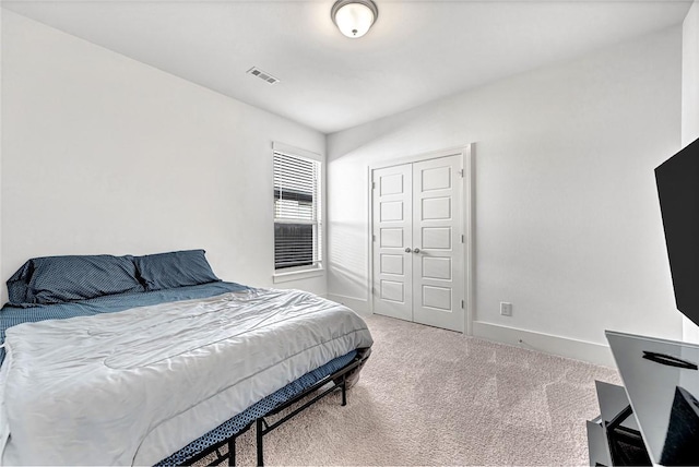 carpeted bedroom featuring visible vents and baseboards