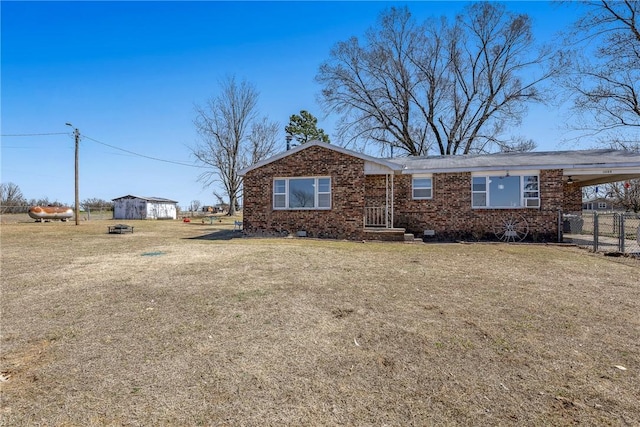 ranch-style house featuring an attached carport, a front yard, fence, crawl space, and brick siding