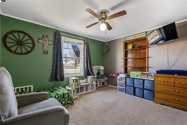 rec room featuring carpet, ceiling fan, and crown molding