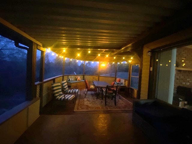 patio at night featuring outdoor dining space