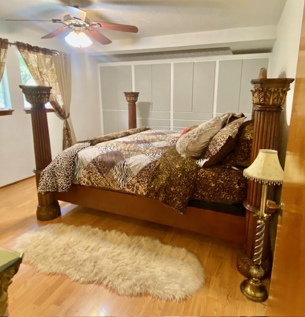 bedroom with ceiling fan and wood finished floors