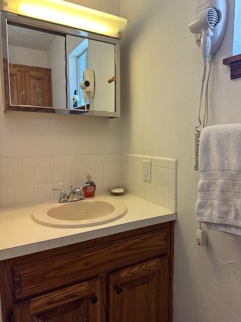 bathroom featuring decorative backsplash and vanity