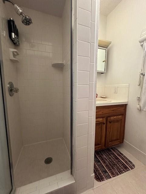 full bathroom featuring vanity, a shower stall, and tile patterned floors