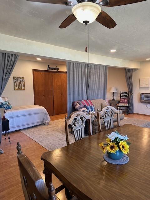 dining room with wood finished floors and ceiling fan