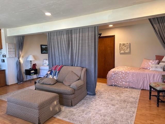 bedroom featuring recessed lighting and wood finished floors