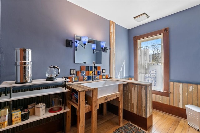 interior space with wooden walls, wainscoting, and hardwood / wood-style flooring