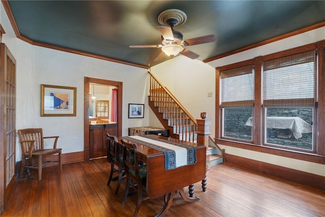 dining room with dark wood finished floors, stairway, ceiling fan, and ornamental molding