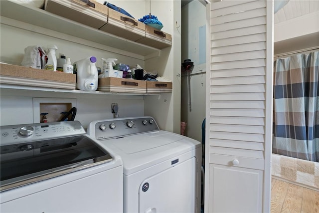 clothes washing area featuring washing machine and dryer and laundry area