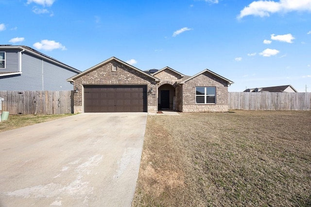 view of front of property with a front yard, fence, concrete driveway, a garage, and brick siding