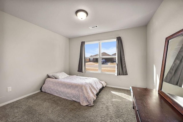 carpeted bedroom featuring visible vents and baseboards