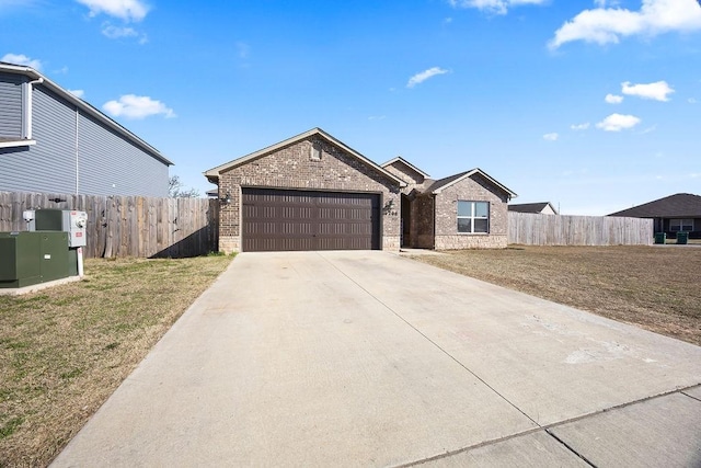 view of front of property with concrete driveway, an attached garage, fence, and brick siding