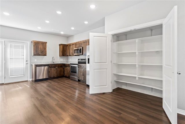 kitchen with dark brown cabinets, baseboards, recessed lighting, dark wood-style floors, and stainless steel appliances