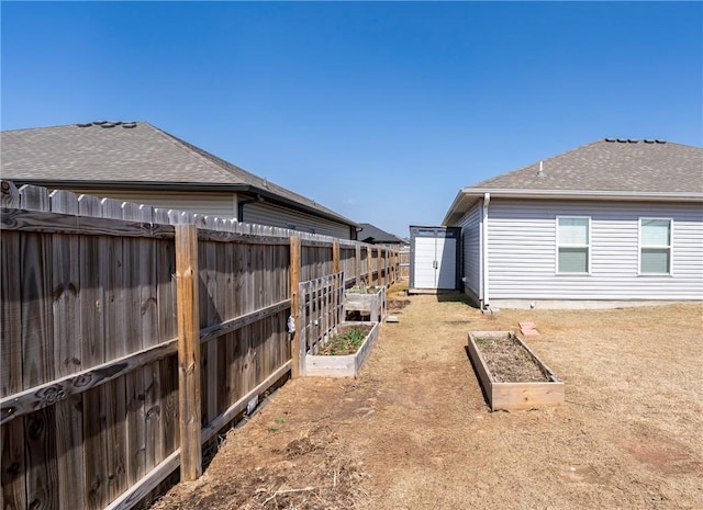 view of yard with fence and a garden