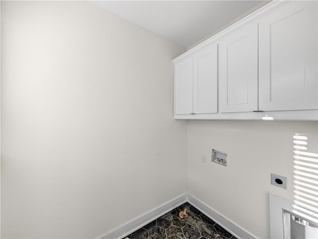 laundry area with cabinet space, hookup for an electric dryer, hookup for a washing machine, and baseboards