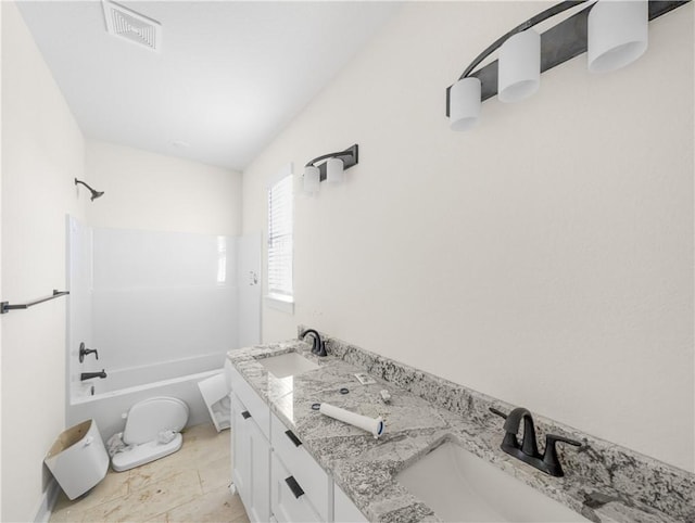 bathroom featuring double vanity, visible vents, shower / bathing tub combination, and a sink