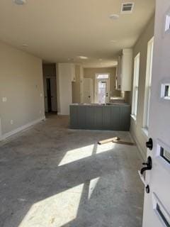 unfurnished living room with visible vents and concrete floors