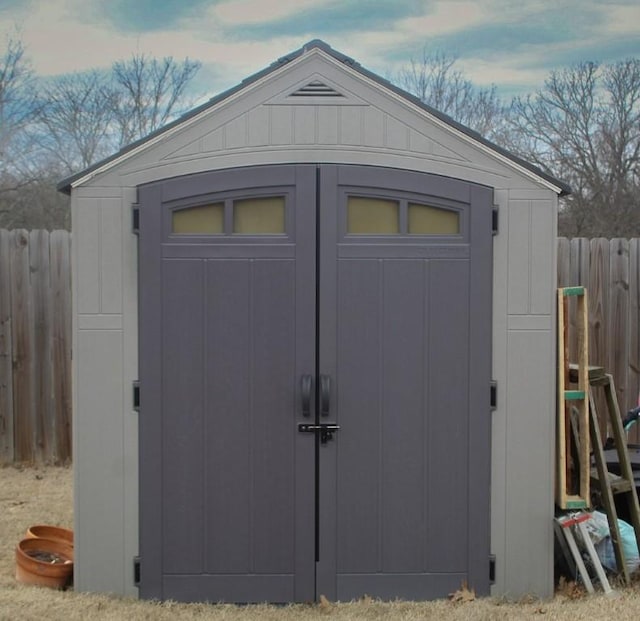 view of shed with fence