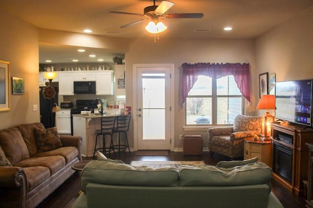 living area with ceiling fan, visible vents, dark wood finished floors, and recessed lighting