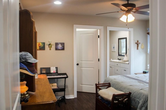 bedroom with a sink, ensuite bath, dark wood-style floors, recessed lighting, and baseboards