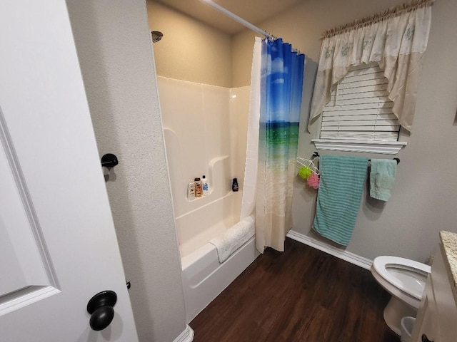 full bath with toilet, shower / tub combo, baseboards, and wood finished floors