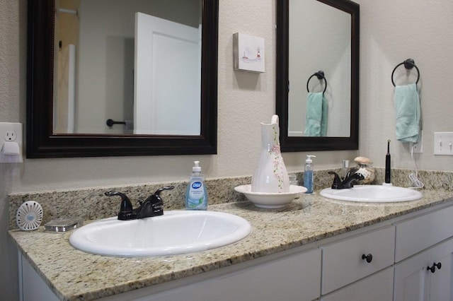 full bath with double vanity and a sink