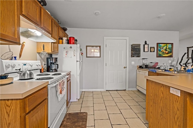 kitchen featuring white appliances, brown cabinetry, light tile patterned flooring, light countertops, and under cabinet range hood