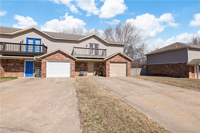 view of front of property with brick siding, concrete driveway, and a balcony