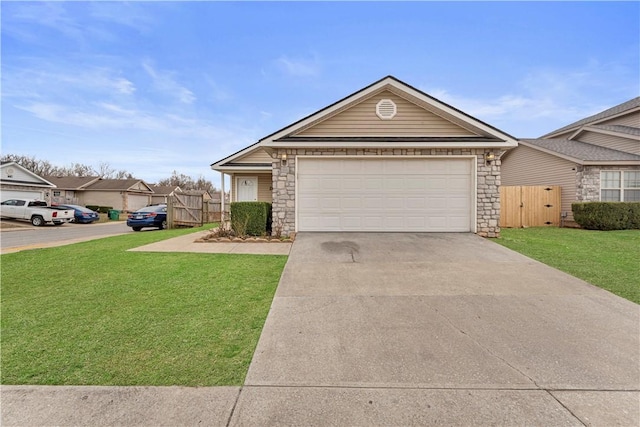 single story home with an attached garage, a front lawn, stone siding, driveway, and a gate