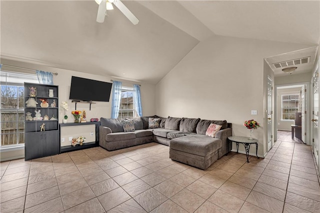 living room with a wealth of natural light, visible vents, a ceiling fan, and lofted ceiling