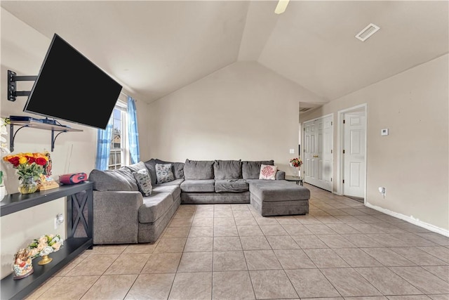 living area featuring light tile patterned floors, visible vents, lofted ceiling, and baseboards