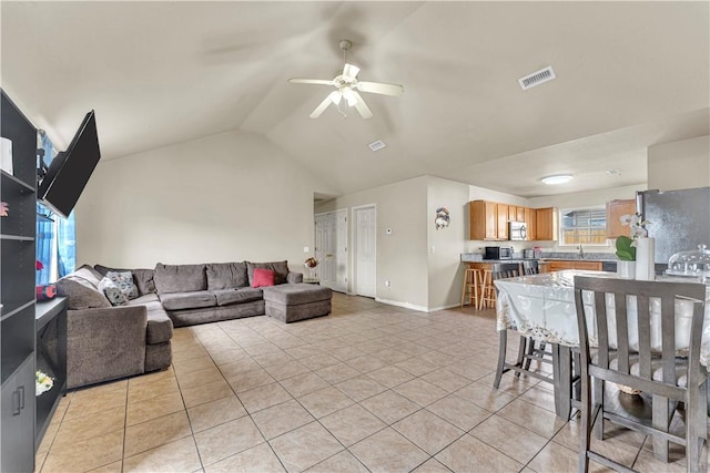 living room featuring light tile patterned floors, baseboards, visible vents, ceiling fan, and vaulted ceiling