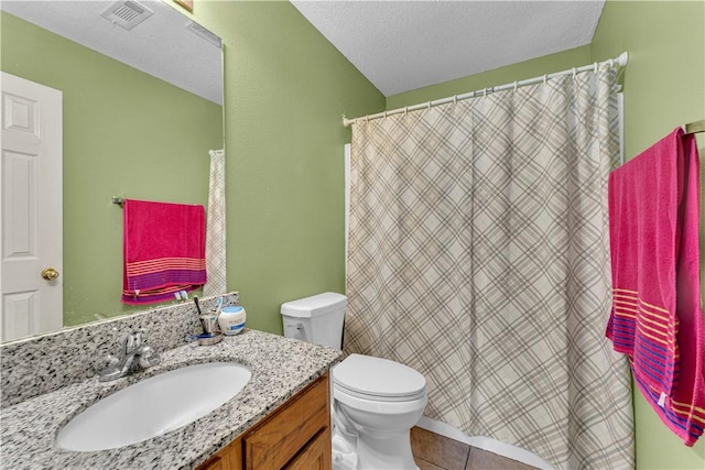 full bathroom featuring vanity, visible vents, a textured ceiling, tile patterned floors, and toilet