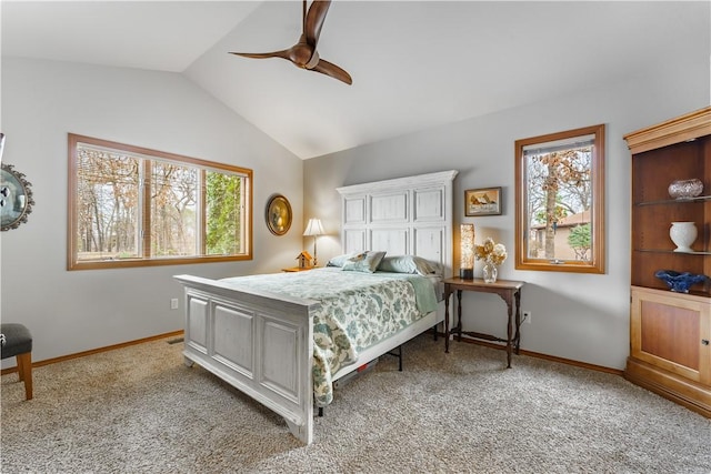 bedroom featuring baseboards, lofted ceiling, light carpet, and ceiling fan