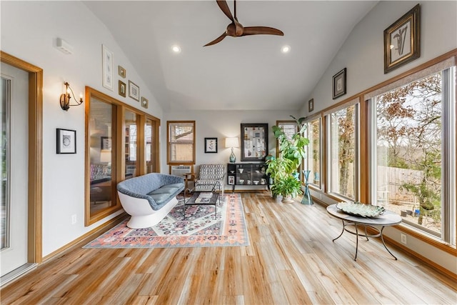 sunroom / solarium with a ceiling fan and lofted ceiling